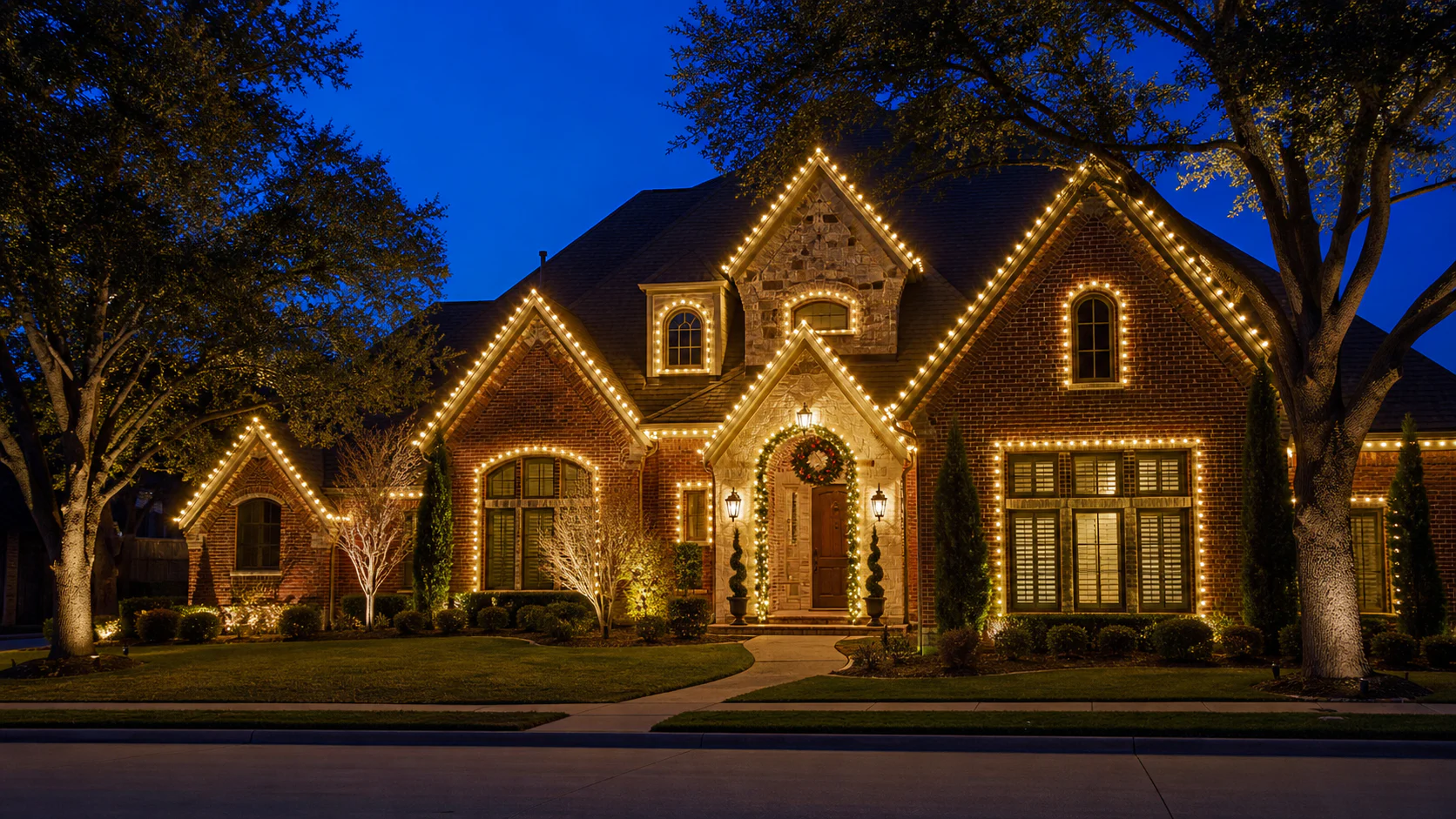Warm-white holiday lights precisely outlining a Dallas-area home's roofline and entry